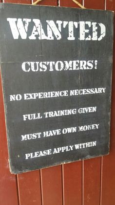 a sign on the side of a building warning customers to not be satisfied with their customer satisfaction