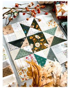 a table topped with lots of different types of quilts