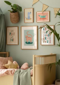 a child's bedroom with green walls and pictures on the wall