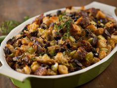 a casserole dish filled with stuffing and vegetables