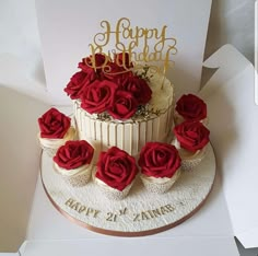 a birthday cake with red roses on top