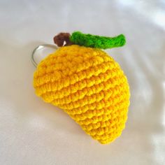 a crocheted lemon keychain is shown on a white surface