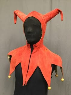 a mannequin wearing an orange and black outfit with horns on it's head