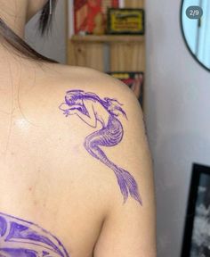 a woman with a purple tattoo on her back