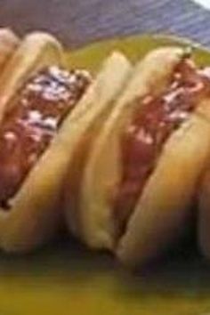 four hotdogs with ketchup and relish on them sitting on a plate