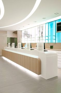 an empty white and wooden counter in a large room