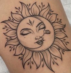 a sun tattoo with the face of a woman's face on her thigh, in black ink