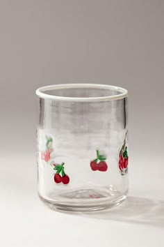 a glass cup with cherries on it