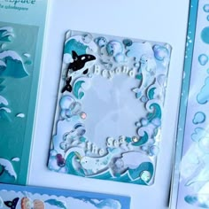 a card with an ocean theme and sea life on the front, surrounded by other cards