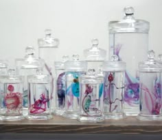 many glass jars with sea animals painted on them