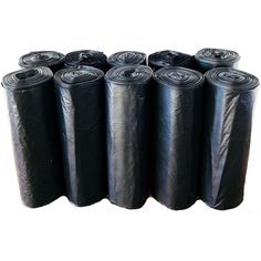 six rolls of black tarp lined up on top of each other with one roll in the middle