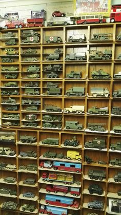 a room filled with lots of toy cars and trucks on shelves next to each other