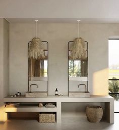 a bathroom with two sinks and mirrors on the wall next to a large window in front of it