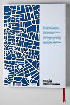 a blue and white book with a red ribbon on the cover that has a city map printed on it