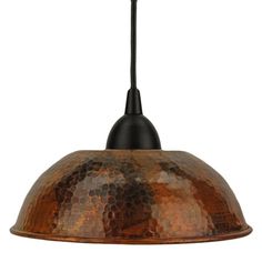 an old fashioned copper colored metal light fixture with a black cord hanging from the ceiling