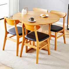 a wooden table with four chairs around it