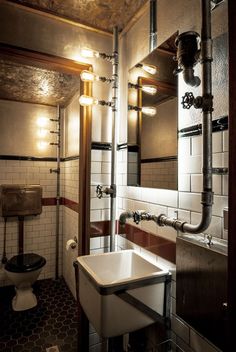 a bathroom with a sink, mirror and toilet