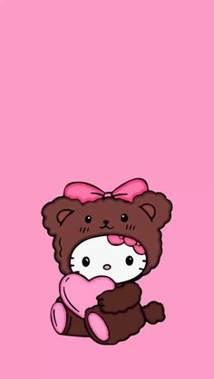 a brown teddy bear with a pink bow sitting on top of it's back