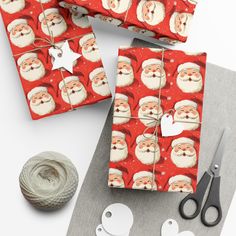 wrapping paper with santa claus on it next to scissors, yarn and balls of twine