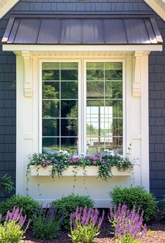 a window box with flowers and plants in it