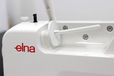 an electric toothbrush dispenser with the word elna on it