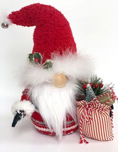 a red and white santa clause hat sitting on top of a potted planter