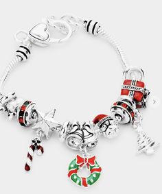 This beautiful Christmas-themed charm bracelet has an elegant look to it and is a fun detail to any outfit. Elegant Christmas Holiday Jewelry, Holiday Festive Jewelry Bracelet, Silver Christmas Holiday Jewelry, Elegant Christmas Bracelet Jewelry, Festive Holiday Jewelry With Dangle Shape, Silver Holiday Jewelry, Festive Holiday Dangle Jewelry, Silver Charm Bracelet For Christmas, Christmas Holiday Bracelet Jewelry