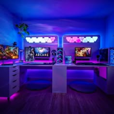 a room with two computers and purple lighting