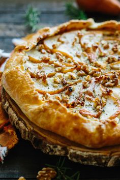 a pizza sitting on top of a wooden table