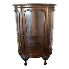 an ornate wooden cabinet with glass doors