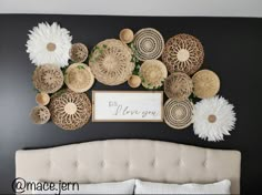 a bed with white and brown decorations on the wall above it's headboard