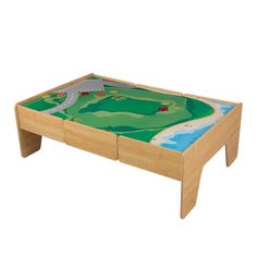 a wooden coffee table with a green landscape painted on it