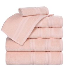 towels stacked on top of each other in light pink colors with white trimmings