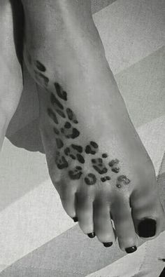 a woman's foot with a leopard print on it