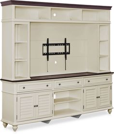 a white entertainment center with a flat screen tv mounted to it's side