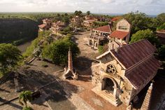 an aerial view of a small village in the middle of a river and trees surrounding it