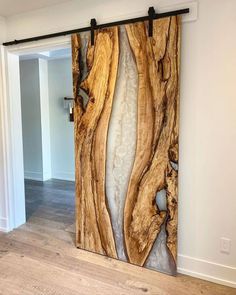 a wooden door with an abstract design on the front and back panels, in a living room