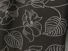 the black and white fabric has small circles on it, as well as lines that are drawn in different directions