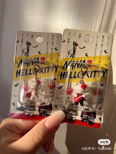 two hello kitty keychains in plastic packaging