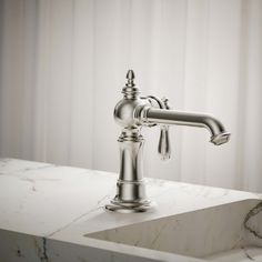 a faucet on top of a white marble counter