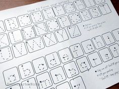 a close up of a keyboard on a wooden table with writing and numbers written on it