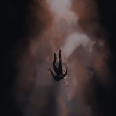 the silhouette of a person reaching up into dark clouds