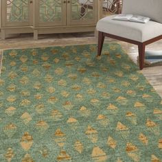 a living room with a green rug and white chair