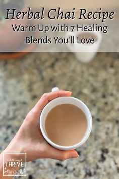 a person holding a cup of tea with the words, herb chai recipe warm up with 7 heating blends you'll love