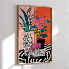 a painting hanging on the wall next to a vase with flowers in it and other items