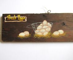 a wooden sign with eggs in a basket