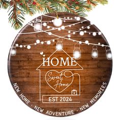 a personalized ornament hanging from a christmas tree with lights and mason jars