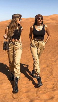 two young women walking in the desert