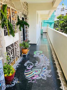 an outdoor walkway painted with chalk and potted plants