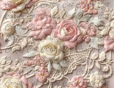 pink and white flowers are embroidered on the side of a lace fabric with an intricate floral design